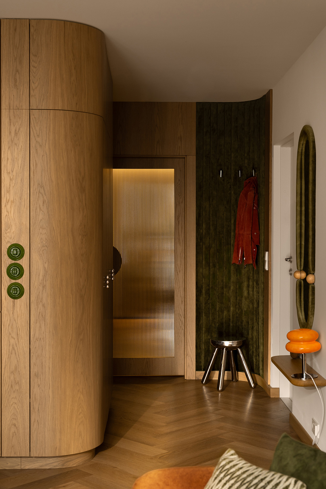 entry area of apartment with green wall accents