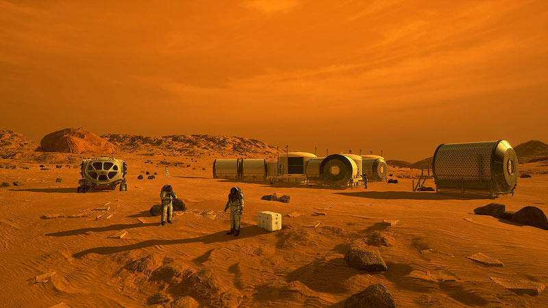 Astronauts and several small cylindrical modular buildings on orange landscape under an orange sky.