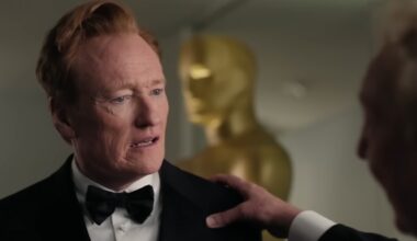 Conan O'Brien with a hand on his shoulder.