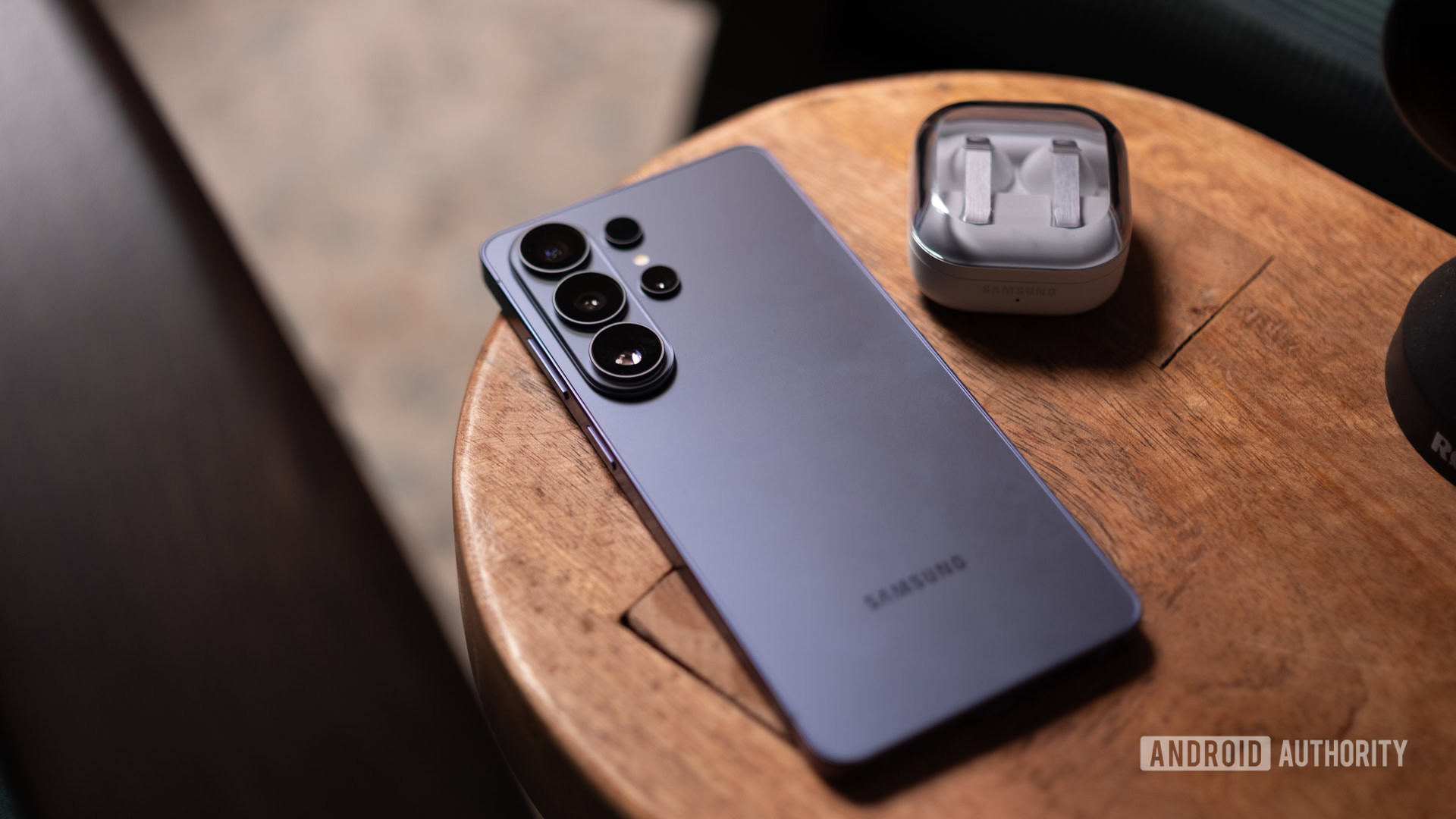 Samsung Galaxy S26 Ultra on table with earbuds