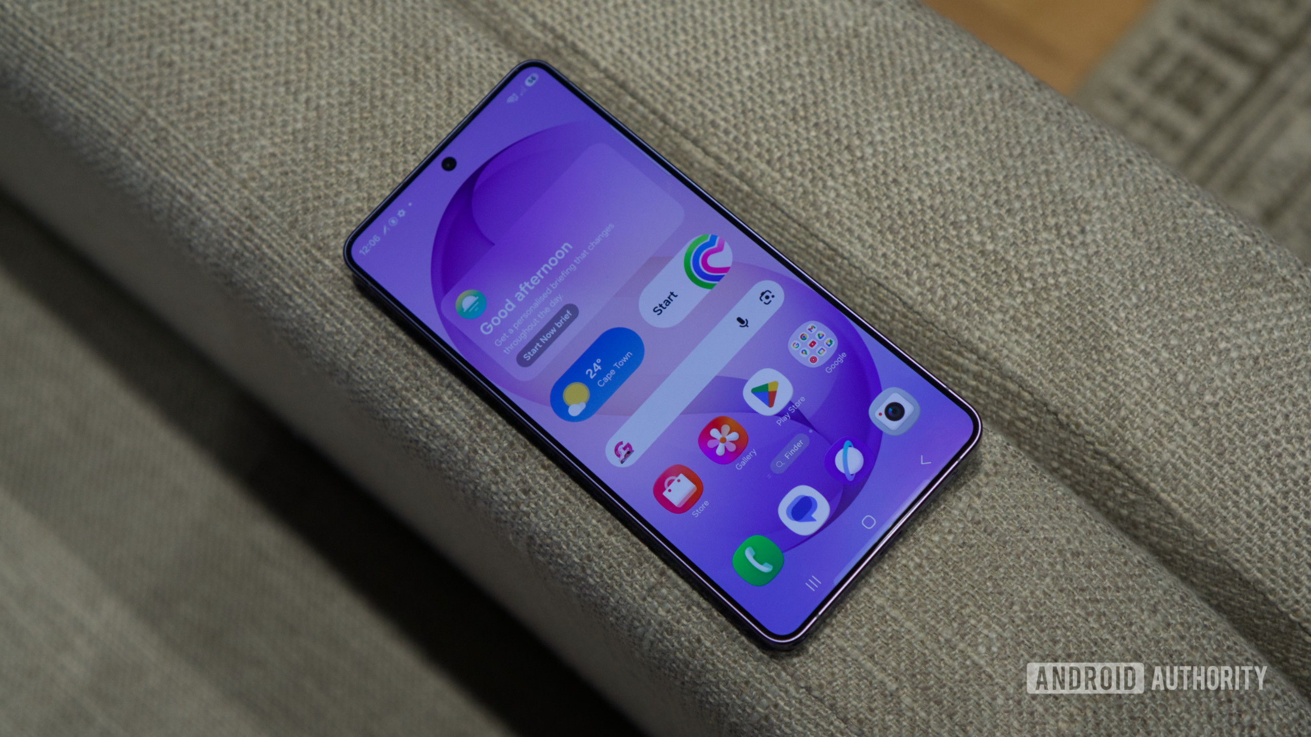 Samsung Galaxy S26 Ultra screen up on couch The Samsung Galaxy S26 Ultra, showing its home screen.