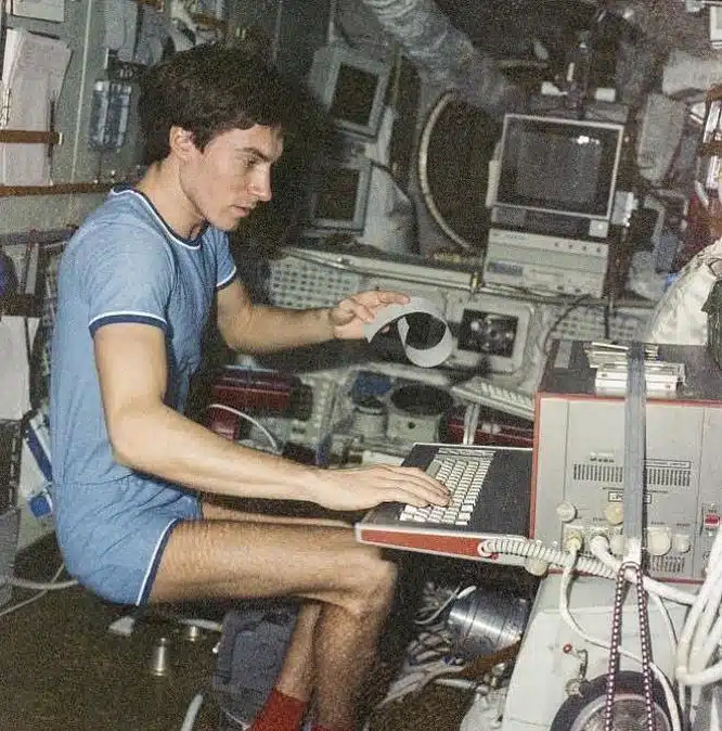 Sergei Krikalev Aboard The Mir Space Station Working On A Computer