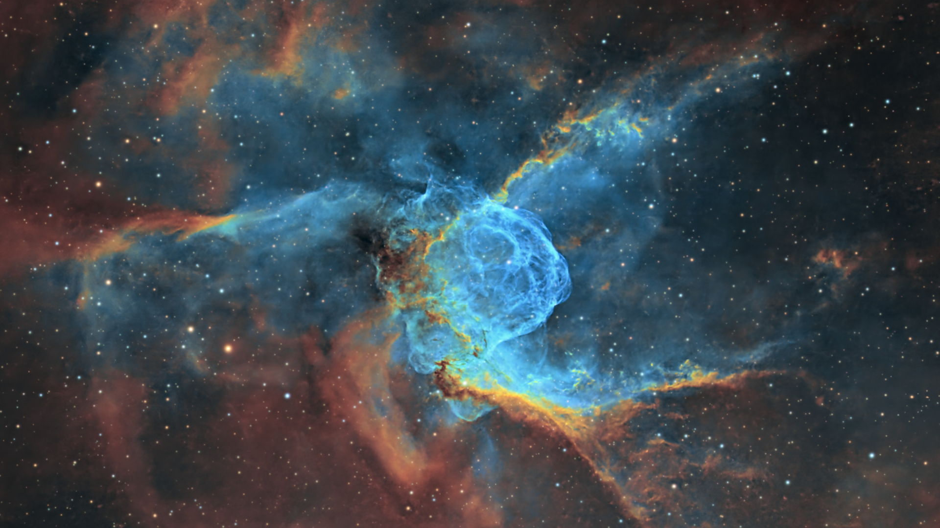 A colourful nebula scene is pictured shining in deep space among a field of stars.