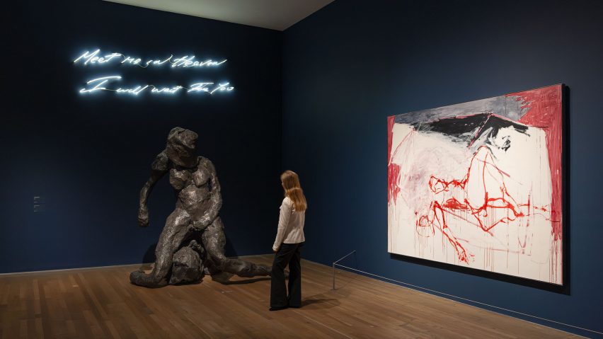 Exhibition visitor looking at figurative bronze sculpture