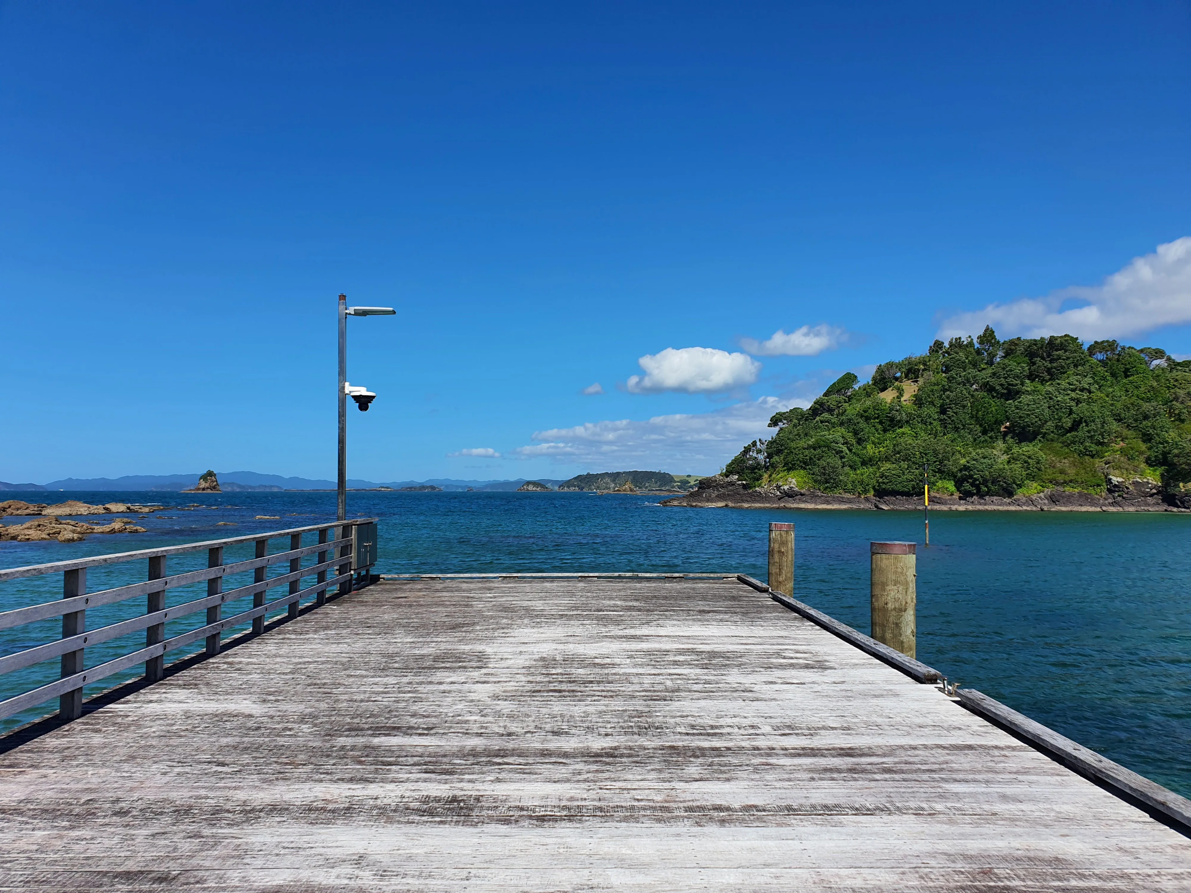 Looking out at the ocean from the pier at The Landing NZ, Purerua Peninsula, Bay of Islands, New Zealand.