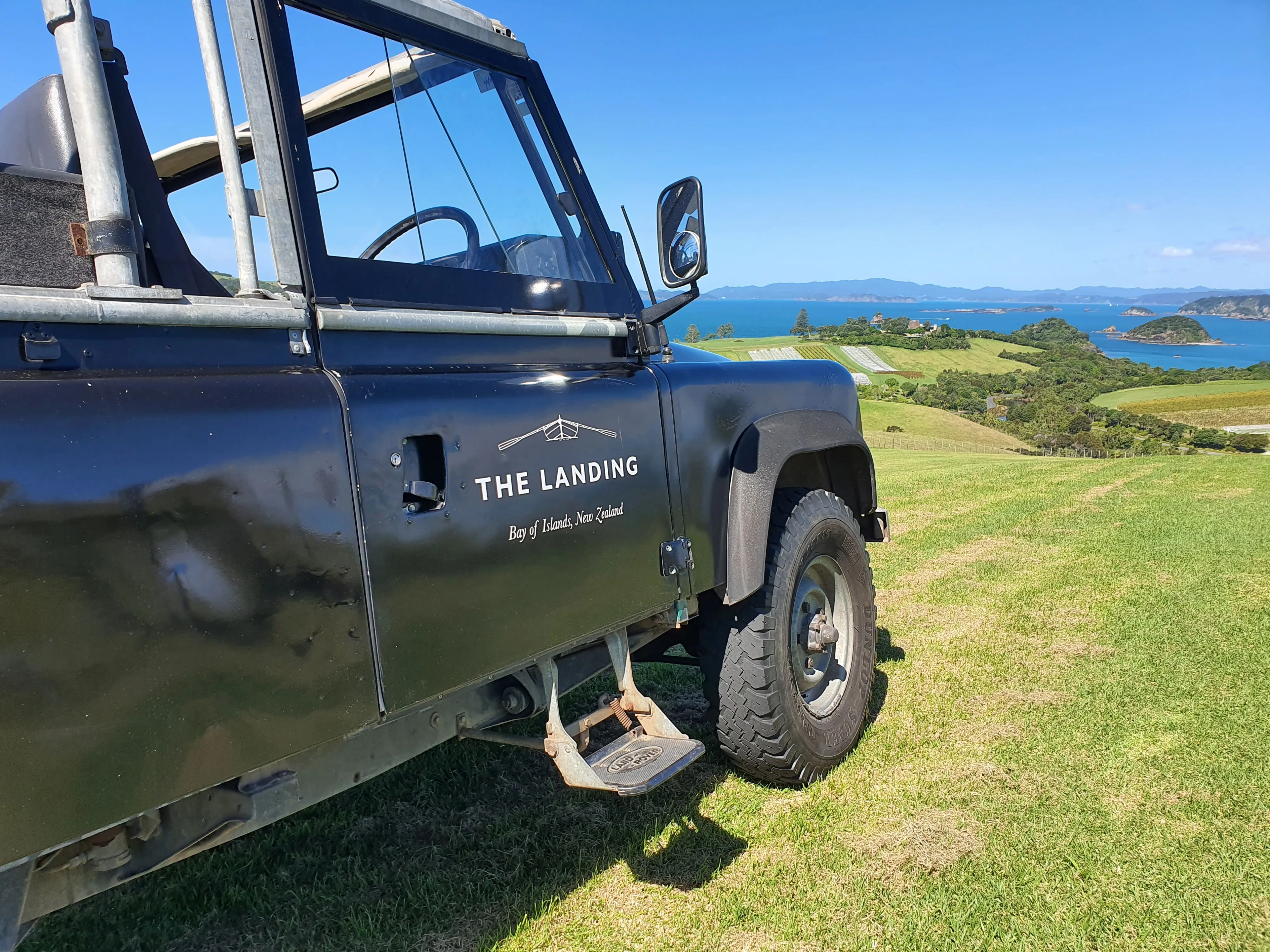 The Landing NZ branded 1984 Land Rover Defender 110 looks out over the Bay of Islands, New Zealand.