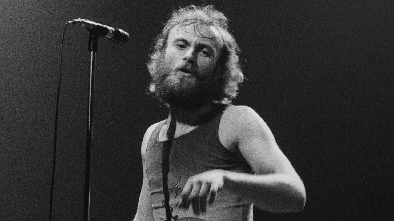 Phil Collins performing on stage with English progressive rock group Genesis, April 1976. (Photo by Michael Putland/Getty Images)