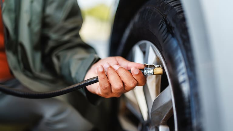 A close-up image shows a person inflating a car tire. (File image). 