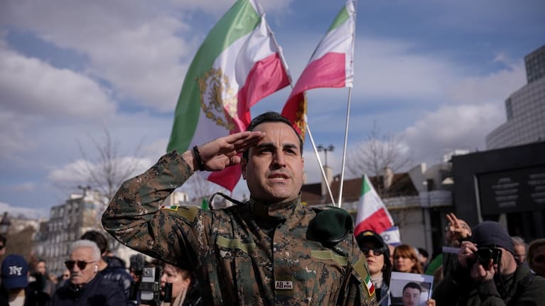 A former Iranian military member gestures during a demonstration in reaction to the US and Israeli strikes on Iran on Sunday, March 1, 2026