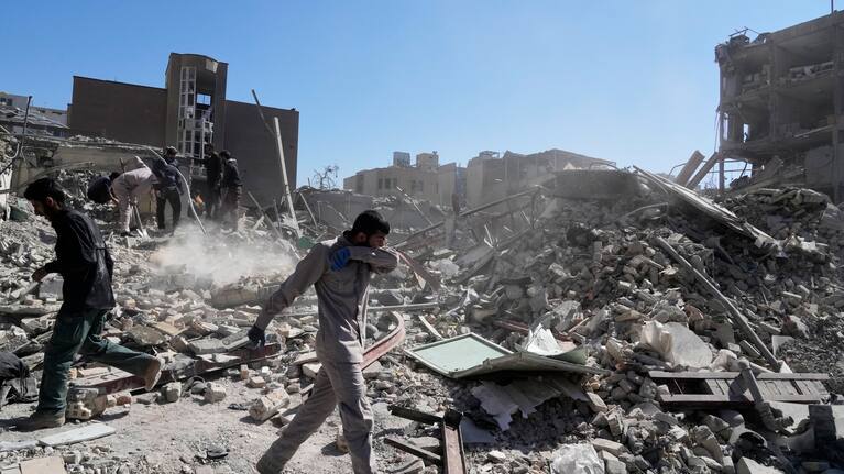 A group of men inspects the ruins of a police station struck Monday amid the US–Israeli military campaign in Tehran, Iran, Tuesday, March 3, 2026.