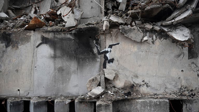A painting by British street artist Banksy is seen on a building destroyed by fighting in Borodyanka, Kyiv region, Ukraine in 2022.