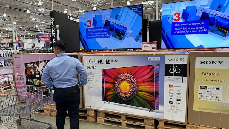 A shopper considers large-screen televisions on display in a Costco warehouse (file image).