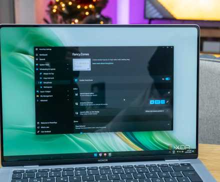 A Windows 11 laptop running PowerToys with the FancyZones settings page open