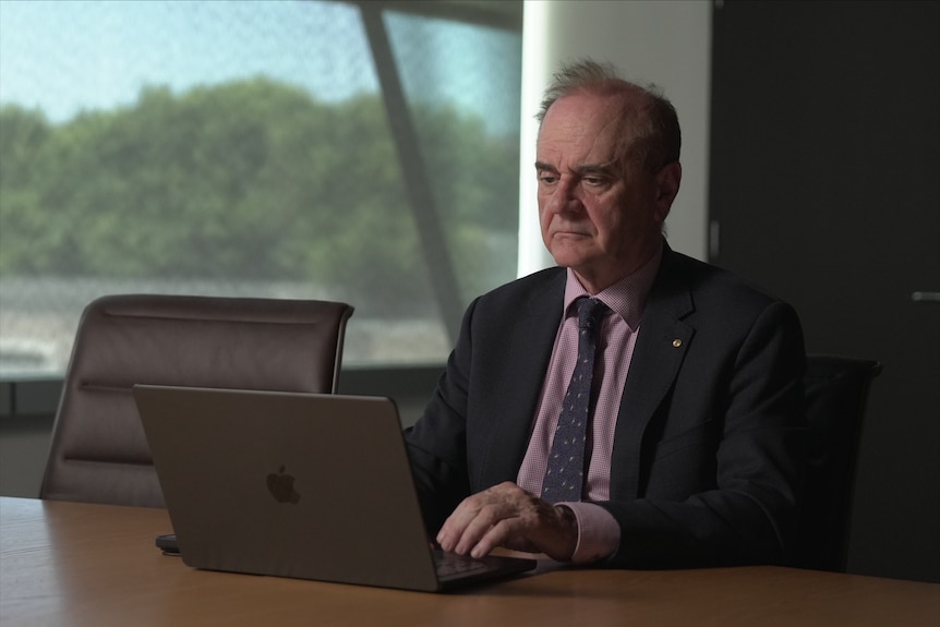 A middle-aged man at a computer