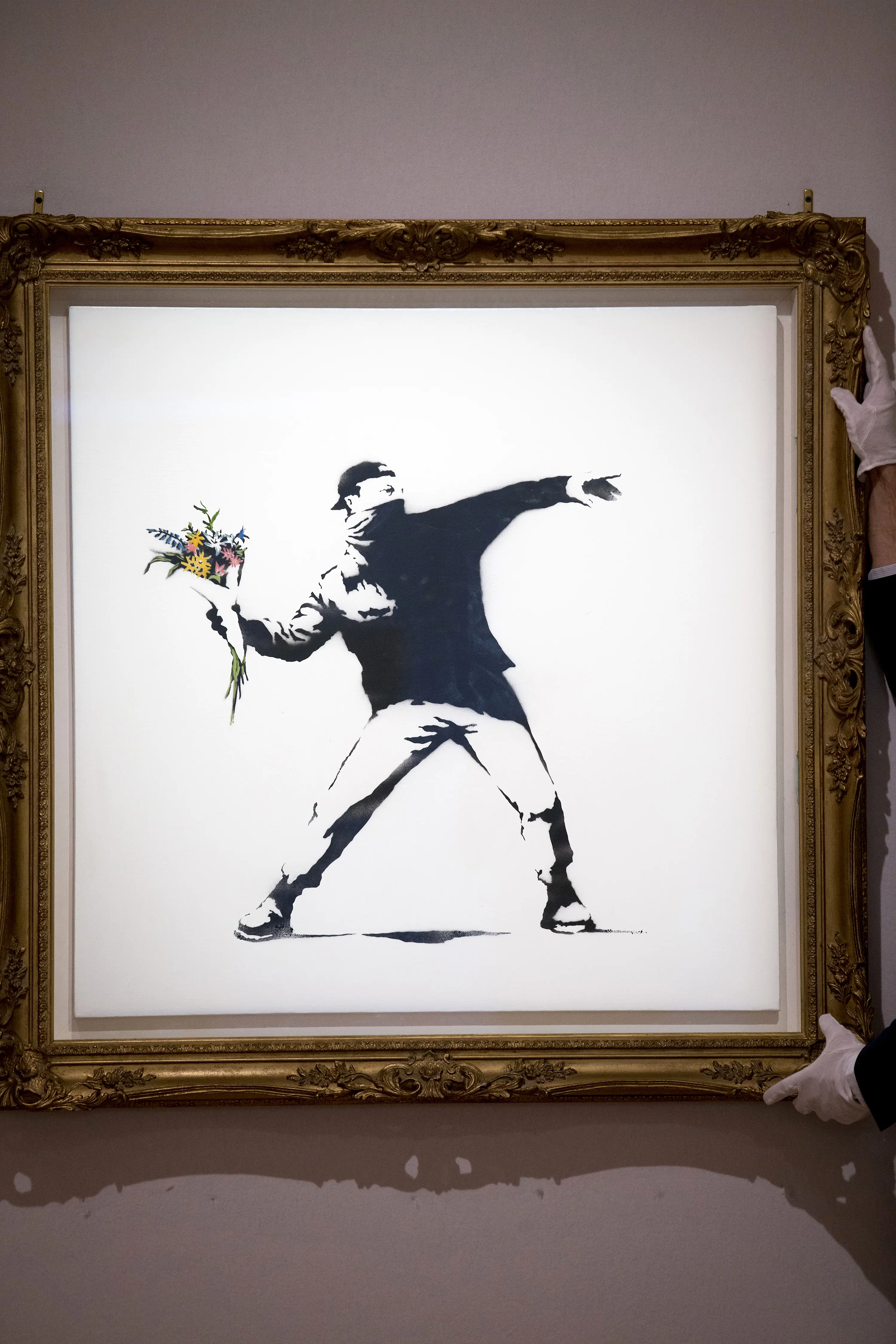 'Flower Thrower' is a well-known piece by street artist Banksy (JUSTIN TALLIS/AFP via Getty Images)
