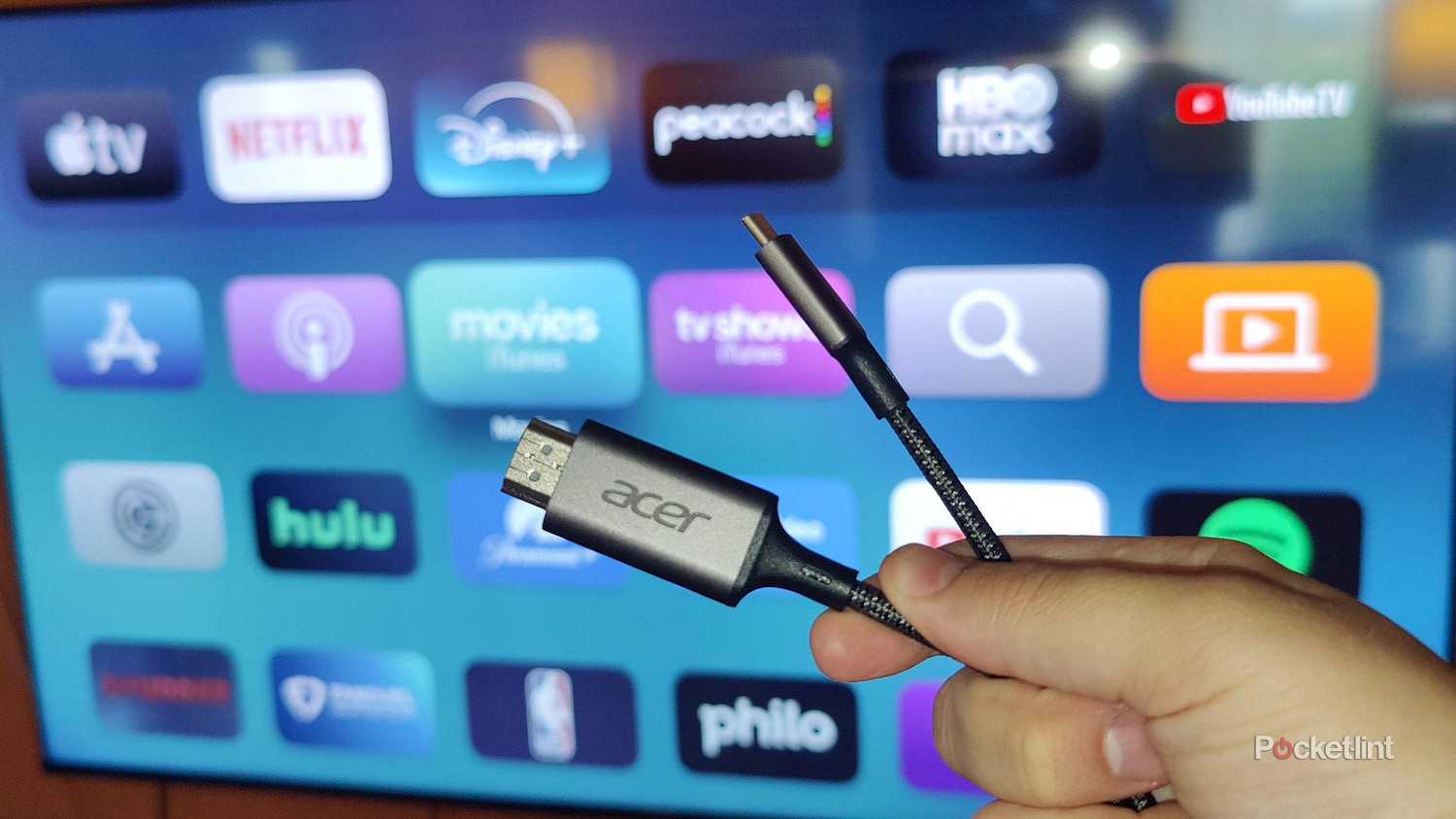 An Acer HDMI cable in front of an Apple TV 4K.