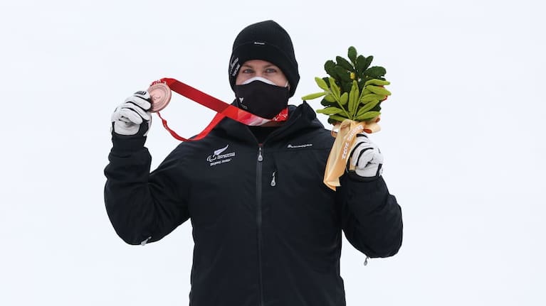 Adam Hall of Team New Zealand poses with a bronze medal following the Para Alpine Skiing Men's Slalom Standing during day nine of the Beijing 2022 Winter Paralympics.