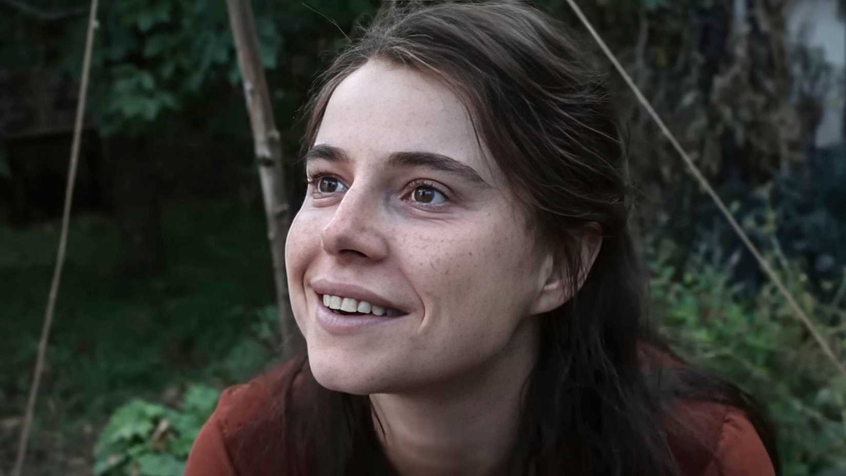 Agnes in close-up smiling in Hamnet