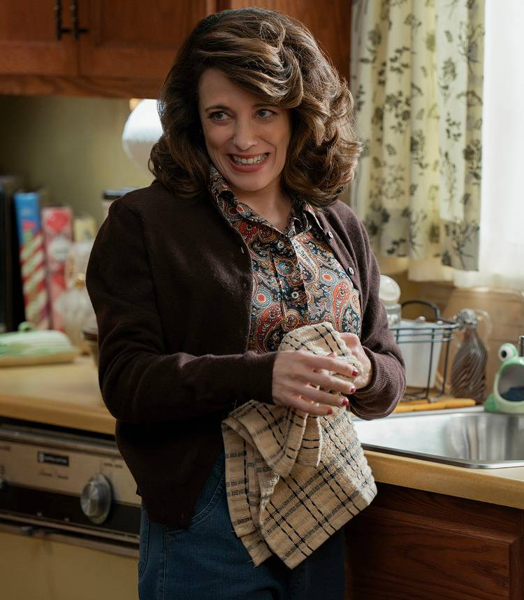 Alanna Ubach's Susan standing in front of the kitchen sink and smiling in Ted season 2
