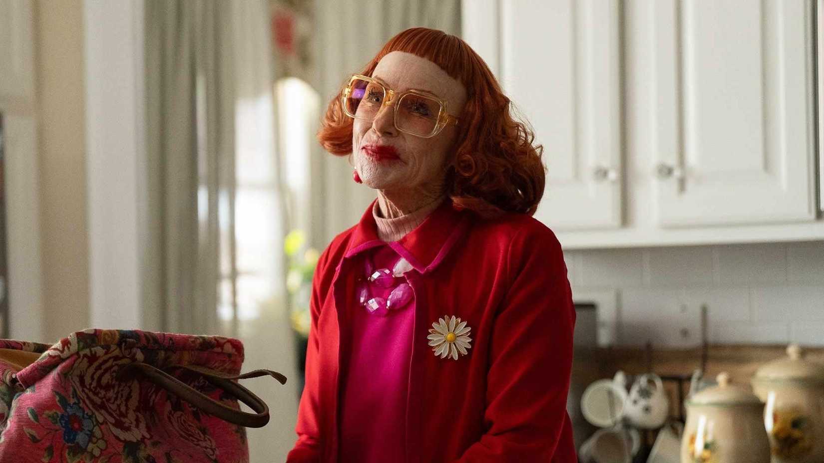 Amy Madigan as Aunt Gladys smiling in a kitchen in Weapons