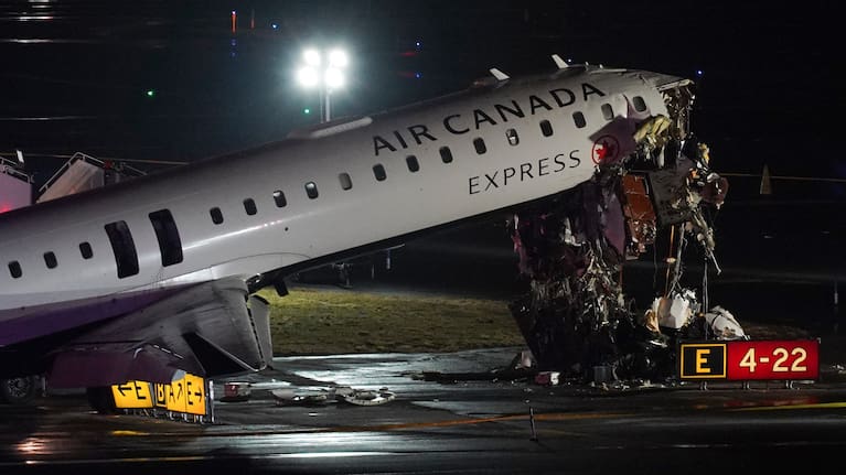 An Air Canada Jet sits on the runway at LaGuardia Airport, Monday, March 23, 2026, after colliding with a Port Authority aircraft rescue and firefighting vehicle in New York. 