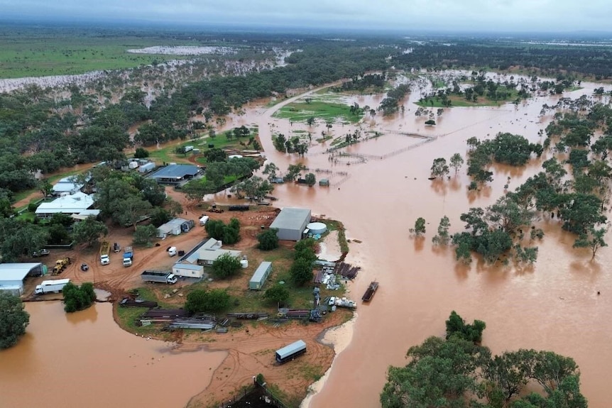 Aerial image of an outback station flooded in by red water