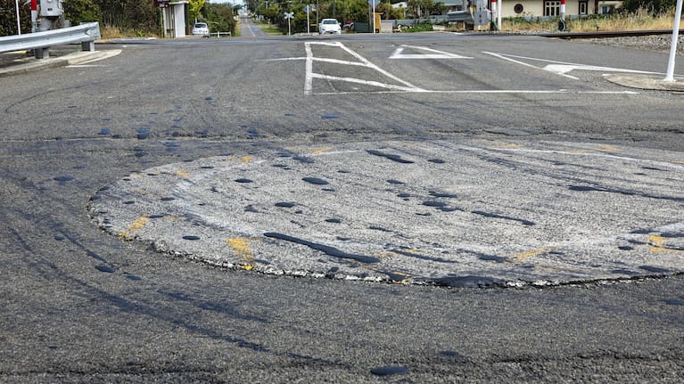Bunnythorpe’s central roundabout, a key intersection between Palmerston North and Fielding, pictured in March covered in tracks and clumps of bitumen. (Source: Adele Rycroft)