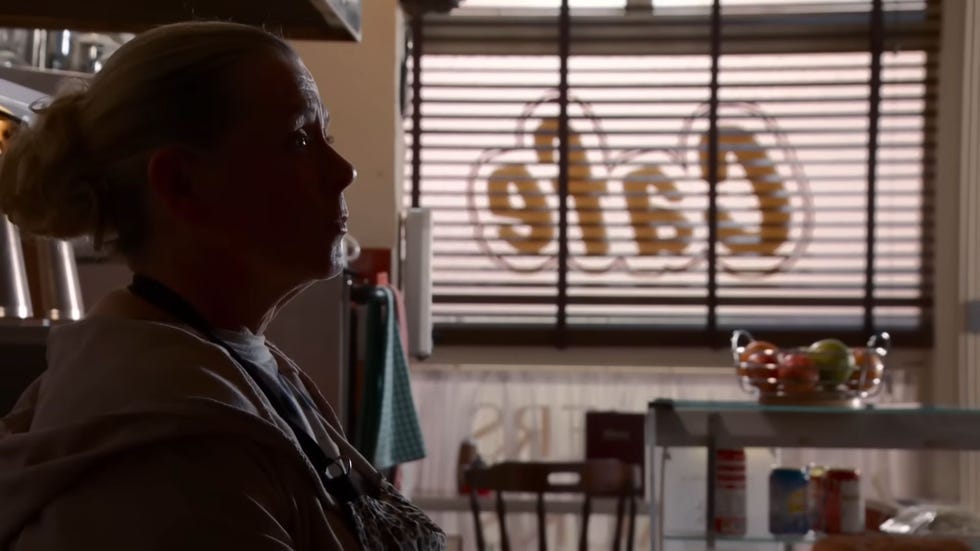 coronation street, bernie winter alahan sitting in the cafe, shrouded in shadow