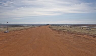 Cryogenic transfer lines on both sides of a road leading to the test article area at Eglin Air Force Base.