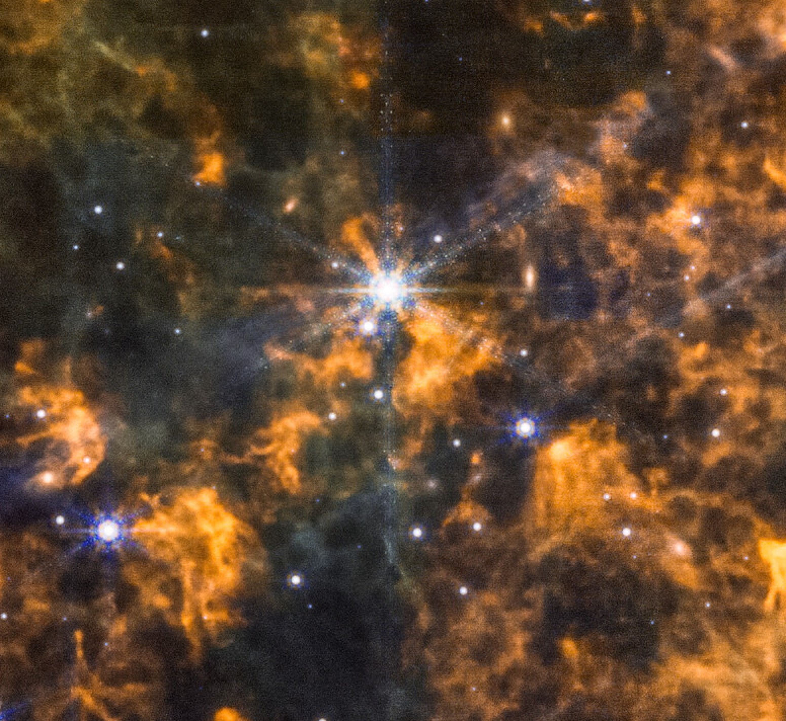 Bright stars are surrounded by glowing orange and yellow interstellar clouds, with a field of smaller stars scattered throughout the image.