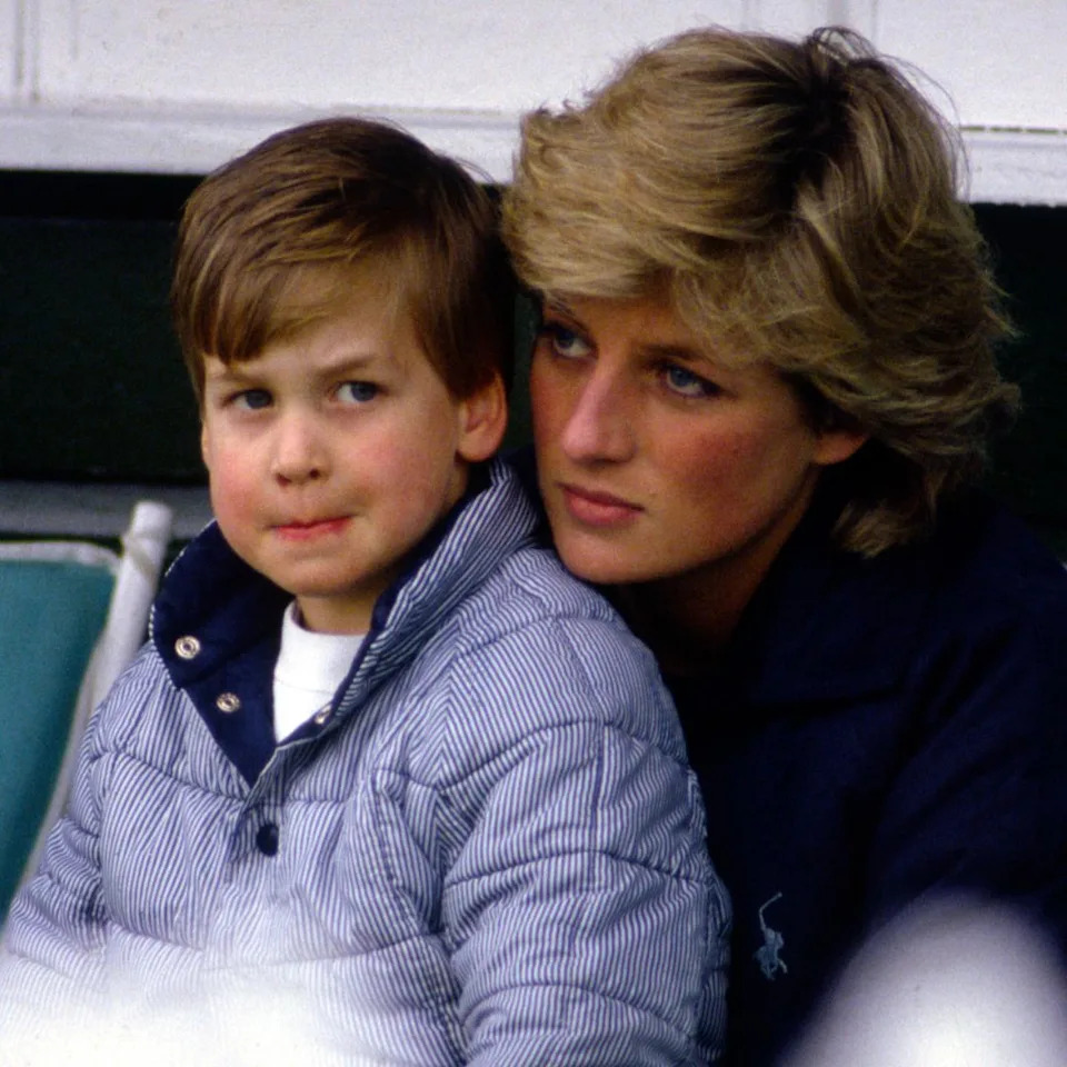 Prince William sits on mom Princess Diana's lap at Guards Polo Club in May 1987 .