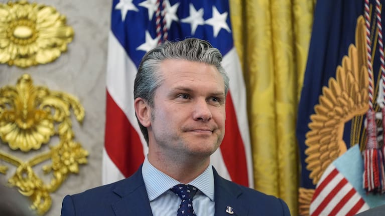 Defense Secretary Pete Hegseth listens as President Donald Trump speaks during the swearing in for Homeland Security Secretary Markwayne Mullin in the Oval Office of the White House.