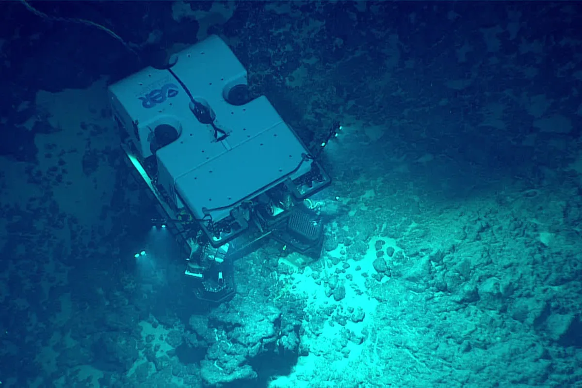 A large submarine searching along the Ocean floor
