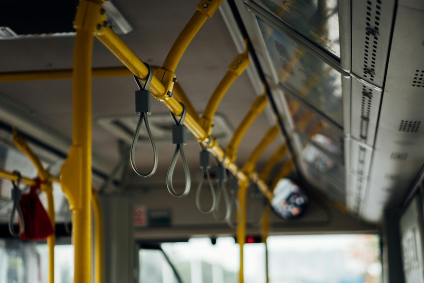 Grey handles and yellow poles on public transport.