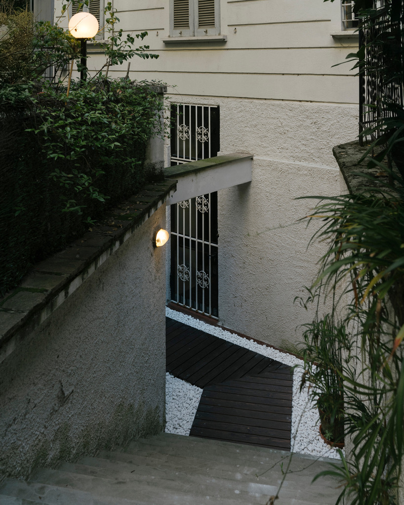 perforated wooden screens filter light and shadow within milan ceramic workshop - 1