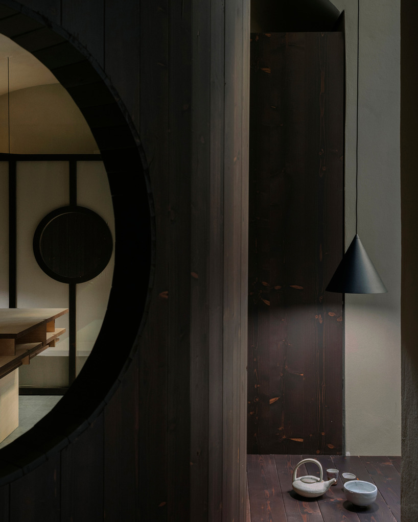 perforated wooden screens filter light and shadow within milan ceramic workshop - 4