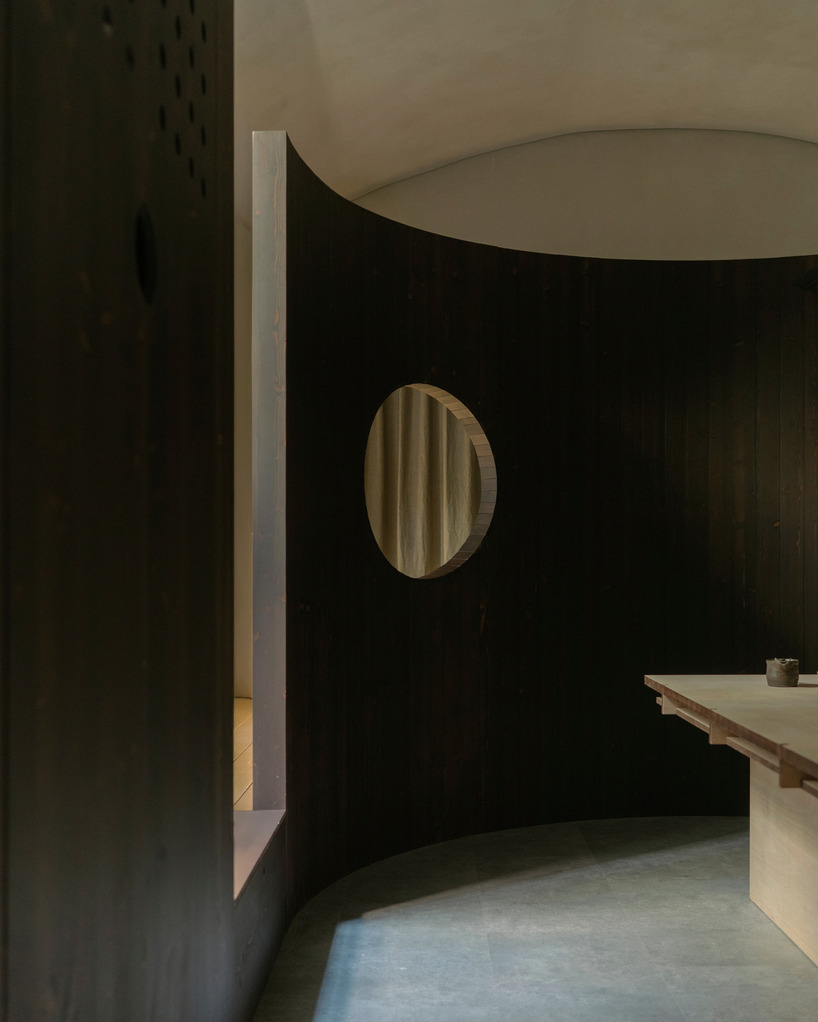 perforated wooden screens filter light and shadow within milan ceramic workshop - 5