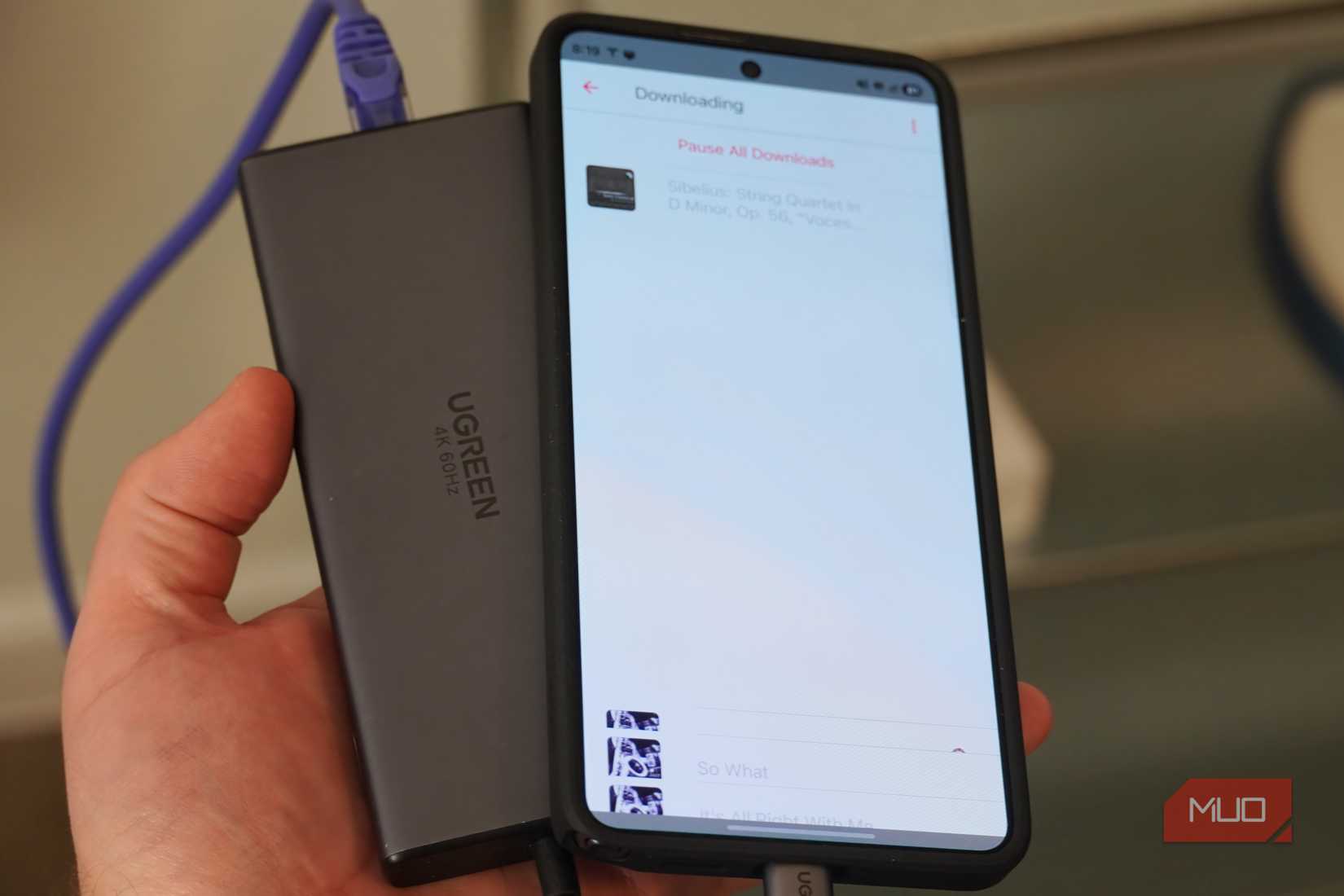 Downloading songs on a phone connected to Ethernet.