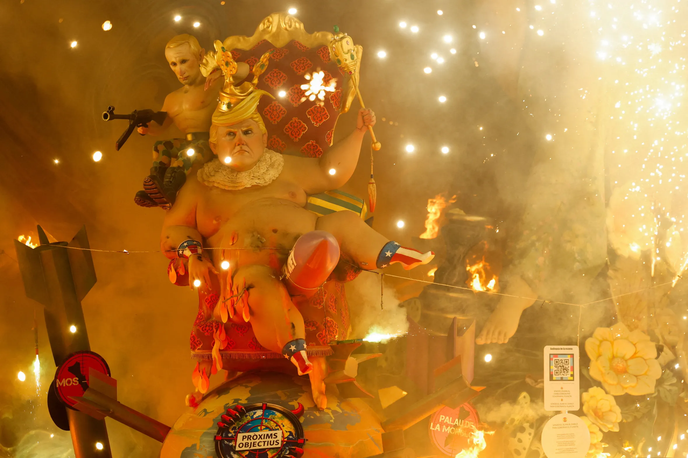 A sculpture of Donald Trump as a baby and Vladimir Putin as a soldier burns during the Fallas Festival in Valencia, Spain.
