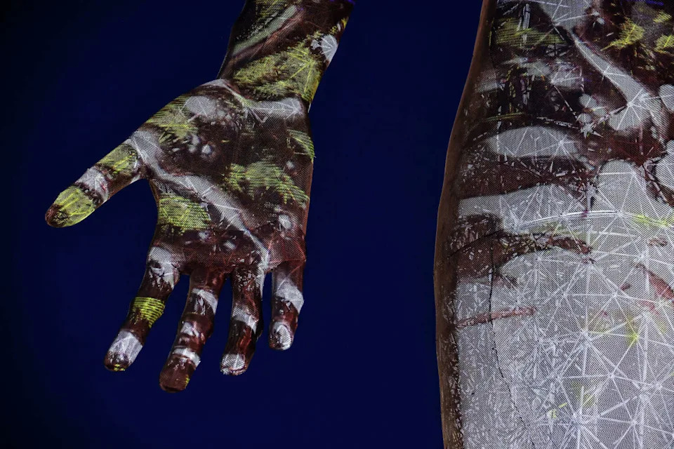 The illuminated hand of the sculpture "R-Evolution," a 45-foot-tall sculpture of a naked woman by artist Marco Cochrane. (Carlos Avila Gonzalez/S.F. Chronicle)
