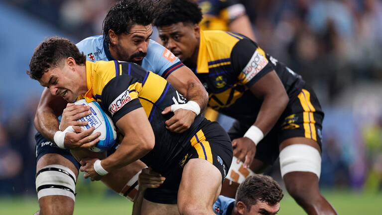 Fehi Fineanganofo of the Hurricanes is tackled during the Super Rugby Pacific Round 4 match between the NSW Waratahs and the Wellington Hurricanes at Allianz Stadium in Sydney