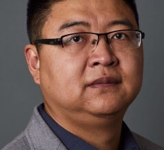 a man in a suit posing for a picture