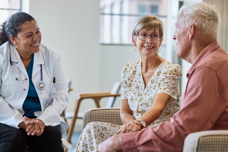 Older adult couple speaking with a doctor