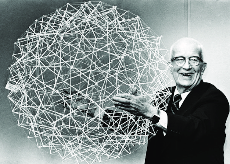 Buckminster Fuller holding a geodesic sphere