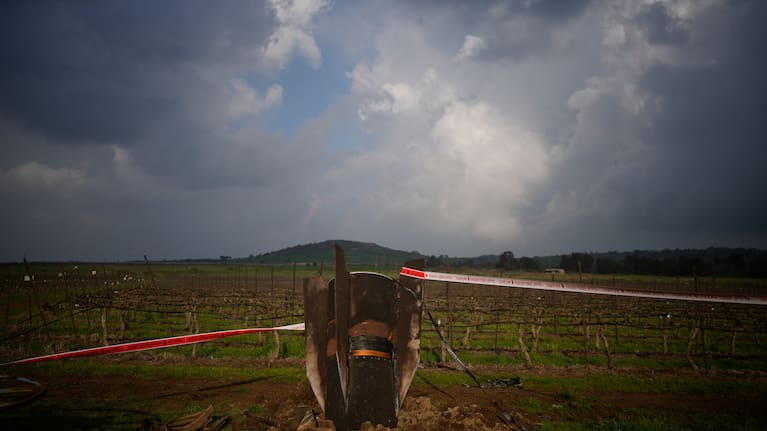 Fragment of a missile fired from Iran, and intercepted by Israeli defense system, sticks out in a open field in the Israeli-controlled Golan Heights, Thursday, March 19, 2026. .
