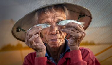 This amateur photographer beat 14,500+ entries to win top prize with this playful portrait of a Vietnamese fisherman