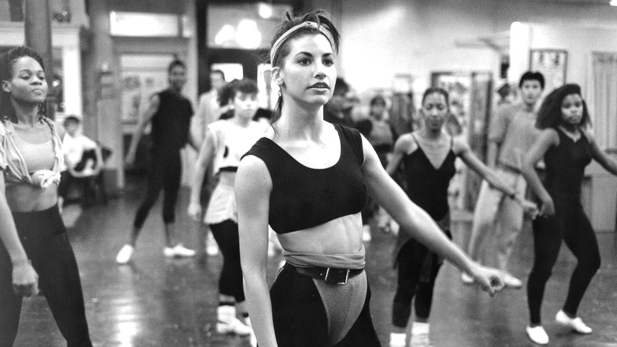 A young Gina Gershon at a dance class.