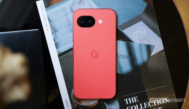 The Berry Google Pixel 10a lying face down on a coffee table.