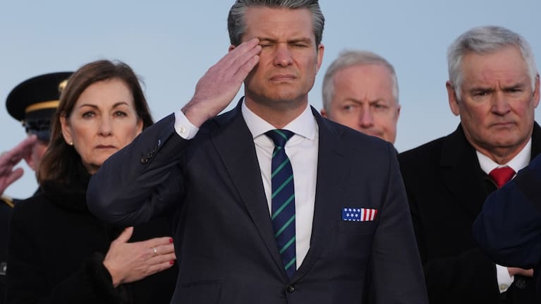 Defence Secretary Pete Hegseth salutes during a casualty return for Iowa National Guard soldiers