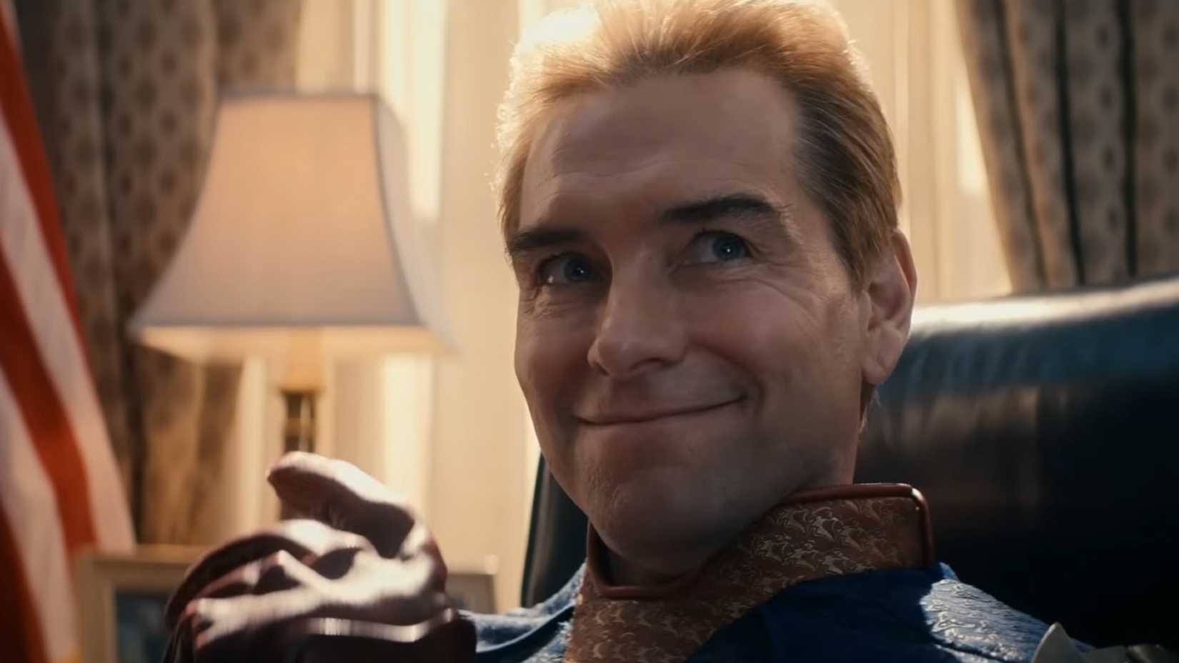 Homelander smiles while sitting at the Resolute Desk in the Oval Office in The Boys season 4(2)